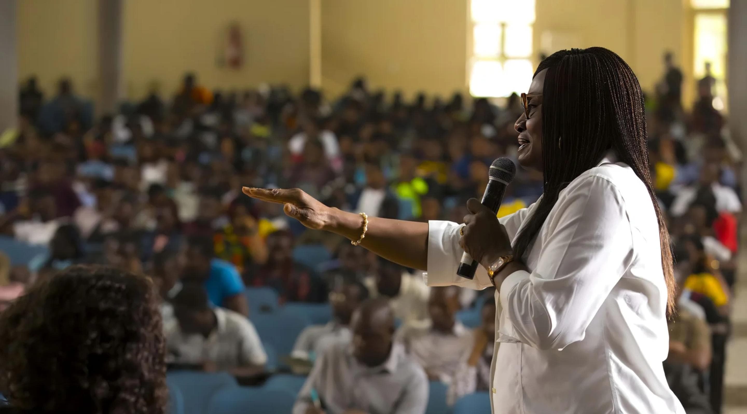 A PFLI speaker addressing a packed hall